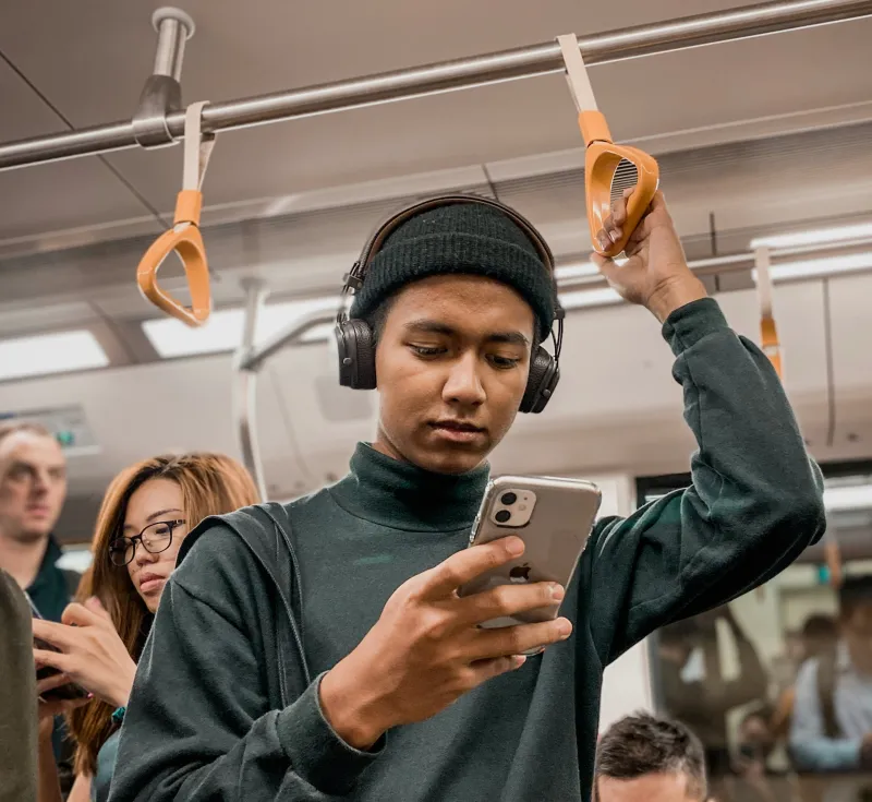 Young man on public transit, representing bringing your real life to the conversation